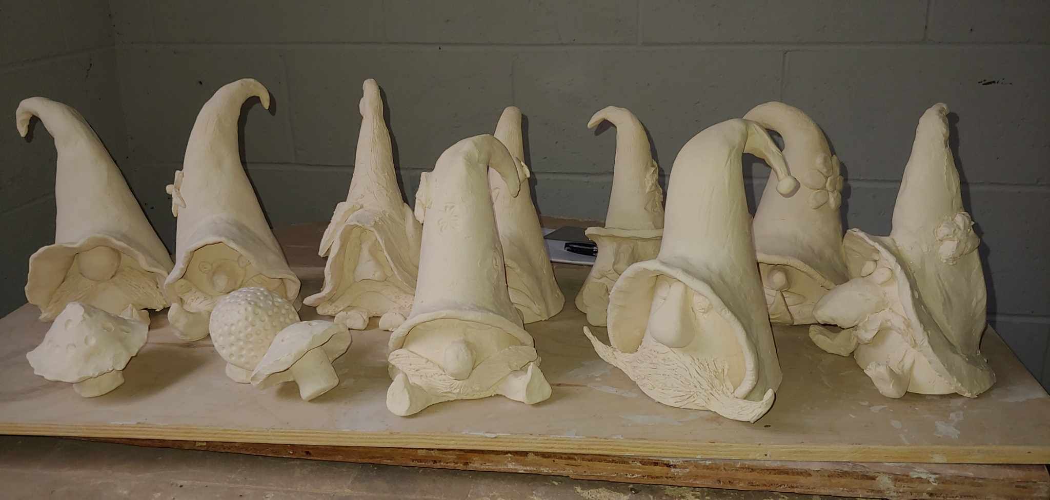Gnomes made at a workshop, bisqued and waiting to be fired.