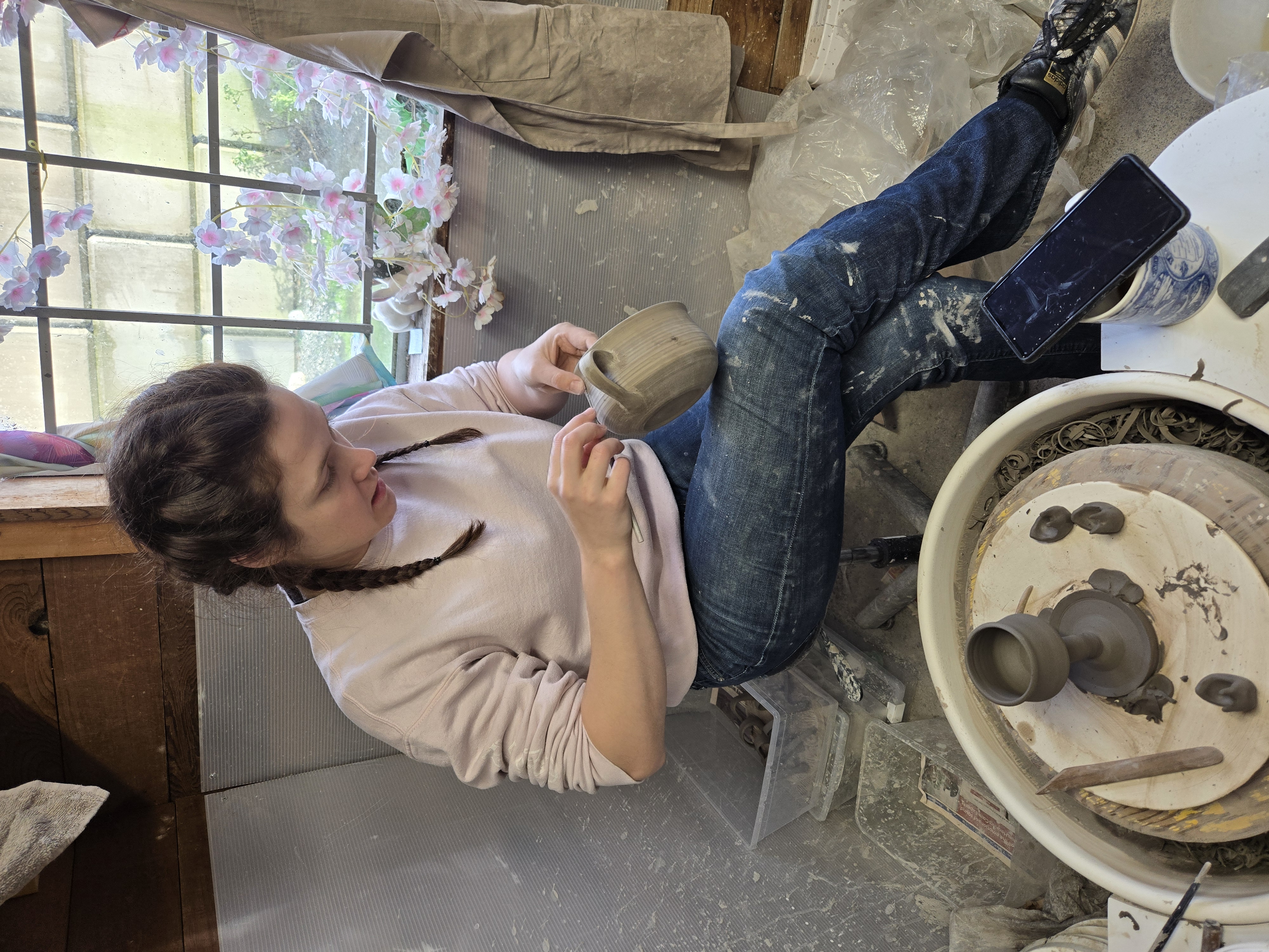 Sara at work trimming a pot